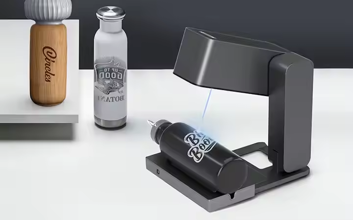 Compact laser engraver in use with cylindrical objects